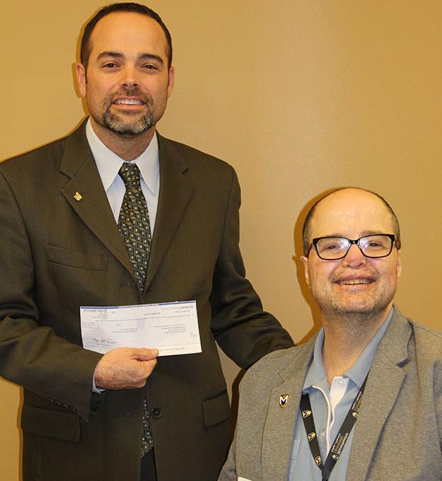 Randy Jennings, right, presents $8,000 to  W. Thomas Smith, dean of Pharmacy Programs at Manchester.